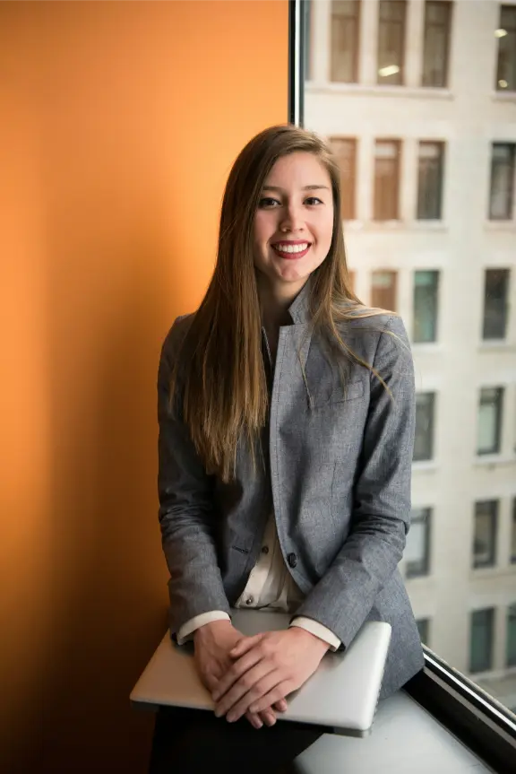 caucasian woman sitting by the window in a suit